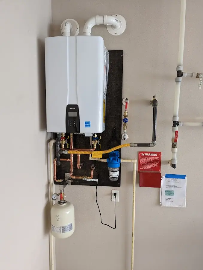 Professional plumber installing copper piping in a Wind Lake home